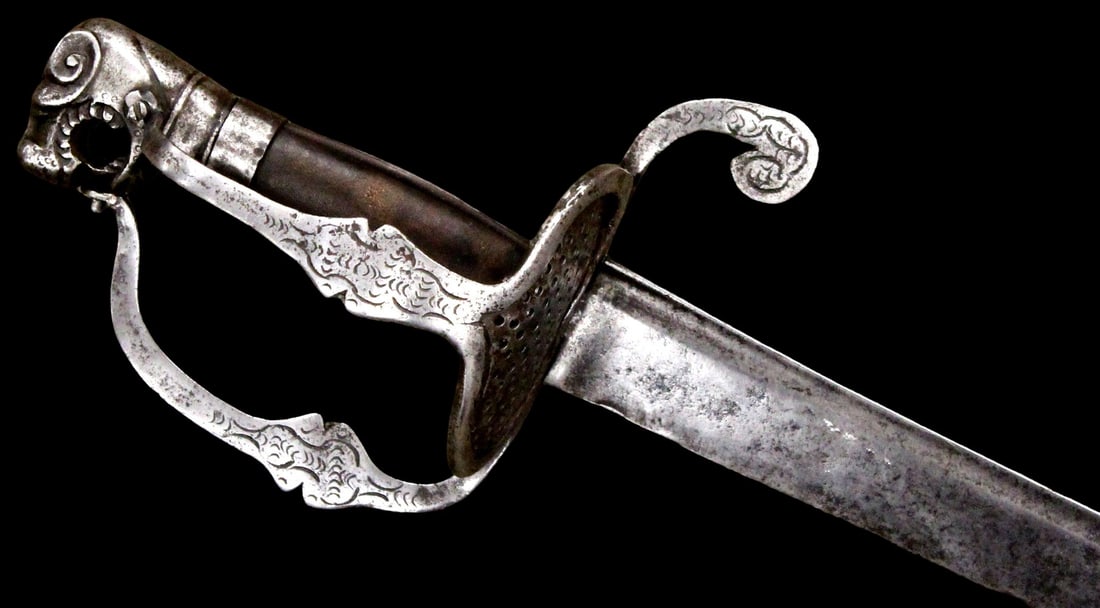 Rare Swiss Lion Pommel Saber Circa 1645 â?? Pierced Shell Guard, Engraved Iron Hilt: A rare and highly desirable mid-17th century Swiss saber, circa 1645, distinguished by its dramatic lion-head pommel (with open-mouth detail) and elegant iron hilt with pierced shell/dish guard, knuck