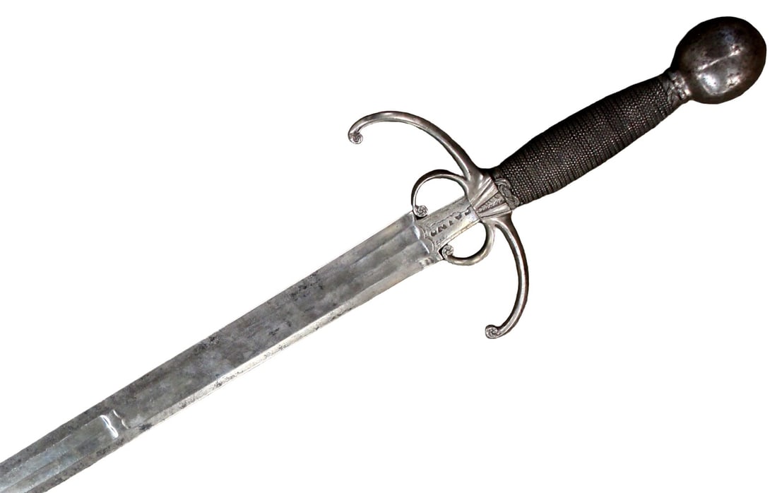 Rare 17th Century Italian Crabclaw Sword ~ ornate pommel with possible inscriptions, Maker Marked: Rare 17th Century Italian Crabclaw Sword. The top of the hilt features an ornate, rounded metal pommel, showing signs of aged patina and possible inscriptions. Strong wide, sturdy maker marked blade,