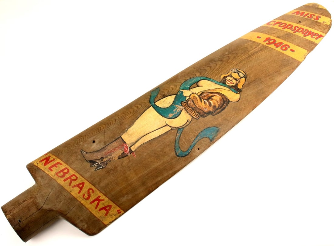 PORTRAIT OF NEBRASKA NUDE AVIATRIX PAINTED ON 1/2 WOODEN CROP DUSTER AIRPLANE PROPELLER: Portrait of Nebraska nude aviatrix painted on 1/2 wooden crop duster airplane propeller 6ft. Painting shows a lady dressed in aviator jacket, scarf, boots & leather helmet as winner of 1946 Miss Crop 