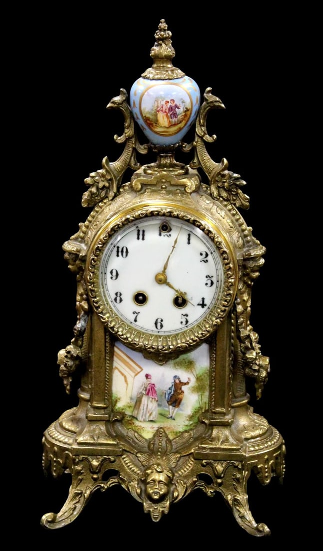 Waterbury Clock Co. Gilt Metal and Porcelain Mantle Clock: Antique 19th century French Rococo style Waterbury gold gilt mantle clock with porcelain finial and porcelain insert . This is a gorgeous 19th century Westbury mantle clock. It is done out of ornate b