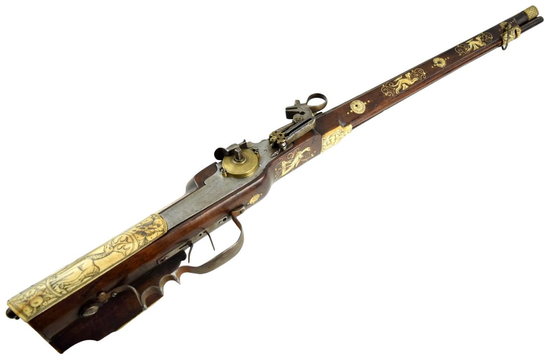 A Fine Inlaid Saxon Wheellock Sporting Rifle With Gilded Wheel Cover Circa 1600.: A Fine Inlaid Saxon Wheellock Sporting Rifle With Gilded Wheel Cover Circa 1600. The swamped muzzle, rifled octagonal barrel struck at the breech with makers mark. The large bore for hunting wild boar