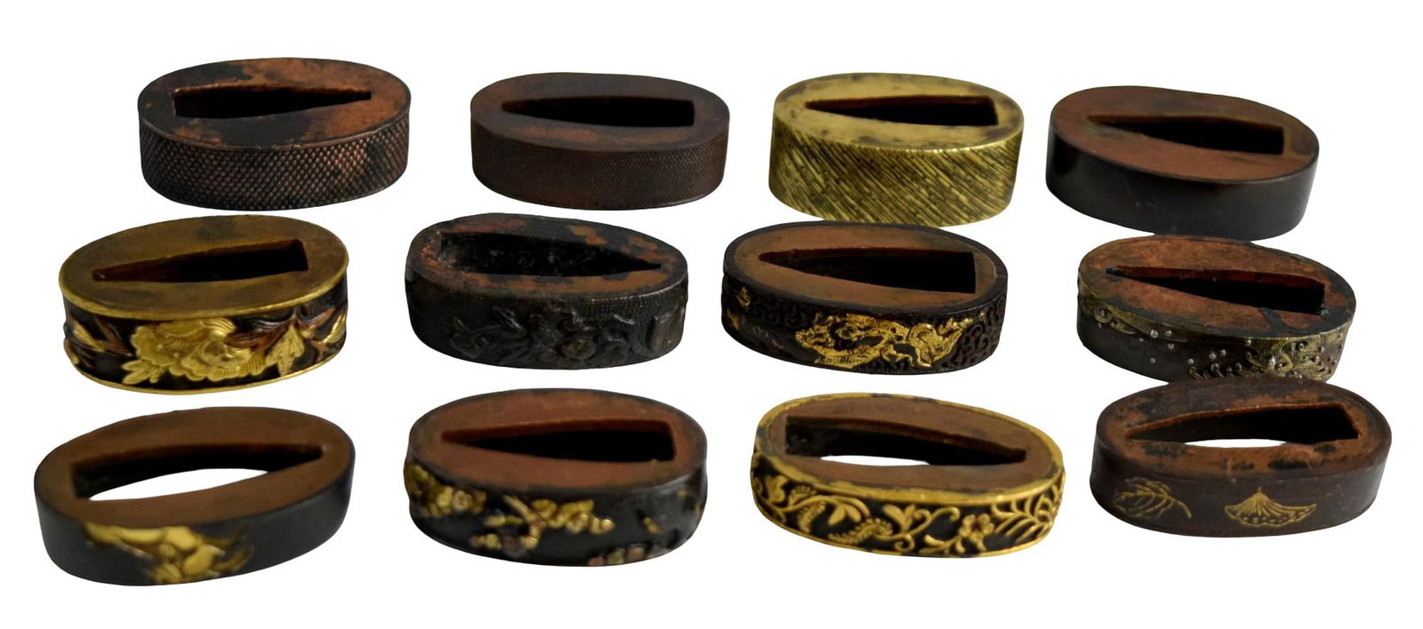COLLECTION OF 12 ANTIQUE JAPANESE SWORD FUCHI FITTINGS: Collection of twelve assorted Japanese sword fuchi, comprising metal hilt fittings traditionally mounted at the upper end of the tsuka beneath the tsuba. Edo to Meiji period, 19th century and possibly