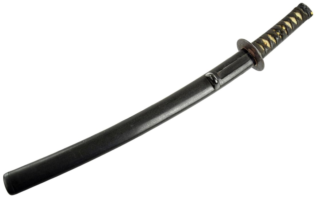 JAPANESE EDO WAKIZASHI KOSHIRAE WITH DECORATED IRON TSUBA: Antique Japanese wakizashi koshirae, Edo period, comprising a complete set of sword mounts fitted with a wooden tsunagi in place of the blade. The tsuka is traditionally mounted with pale samegawa and