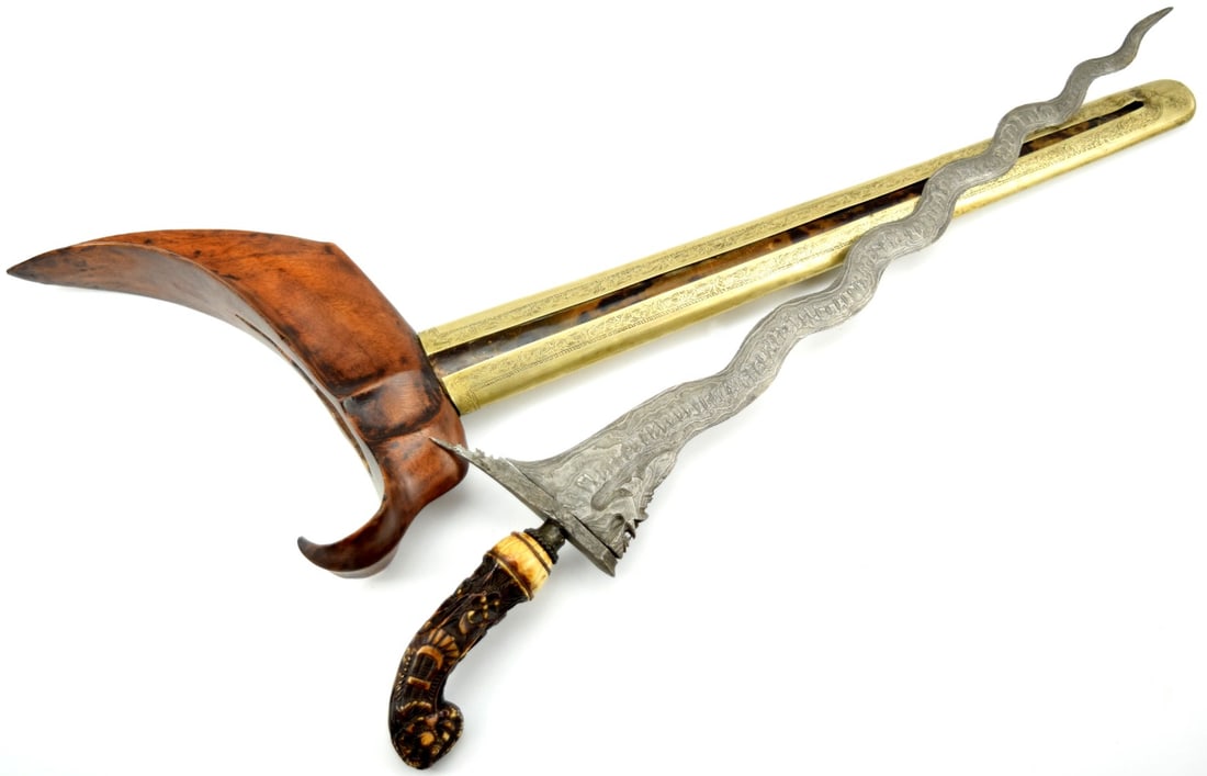 Indonesian Kris with Carved Grip: Indonesian Kris with Carved Grip. Wavy decorated blade with wooden and metal scabbard. Total length (inside scabbard if present) : 18 3/4", Blade length : 14 3/4". ~~ For additional images please visi