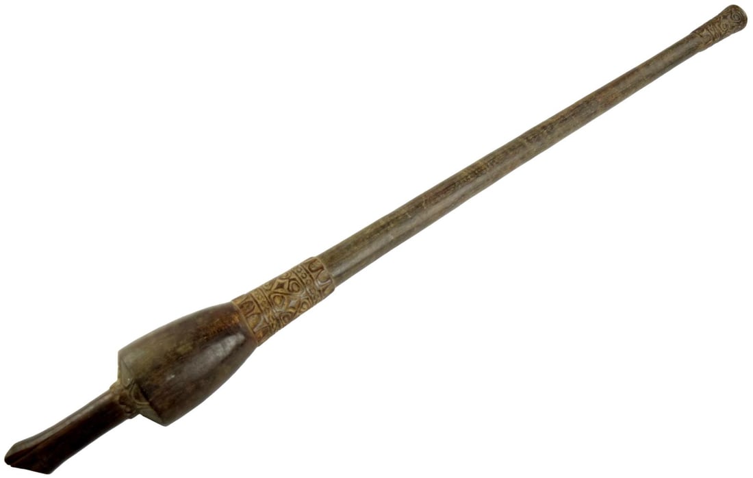 ANTIQUE INDONESIAN BORNEO DAYAK CARVED WOOD BLOWGUN BLOWPIPE: Antique Indonesian carved wooden blowgun or blowpipe, associated with the indigenous Dayak cultures of Borneo, likely 19th to early 20th century. Carved from hardwood with a long, slender tubular body