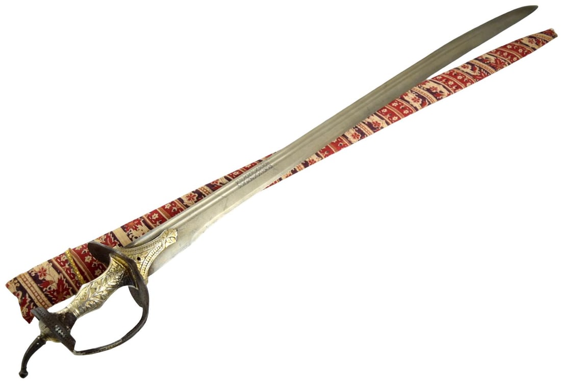 Fine 18thâ??Early 19th Century Indian Firangi Sword with Wootz Steel Blade, Silver & Gold: A particularly attractive Indian firangi sword, dating to the 18th to early 19th century, mounted with a long straight steel blade showing a visible watered surface consistent with wootz steel. The bl