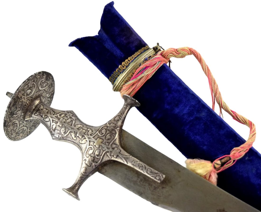 18th Century Indian Tulwar with Silver-Koftgari Hilt and Damascus Steel Blade: An attractive 18th century Indian tulwar featuring a broad, gently curved steel blade displaying a visible watered or Damascus-type pattern. The blade is fitted with a traditional all-steel Indian hil