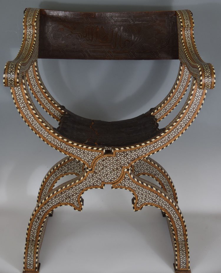 Persian Islamic inlaid folding X chair: 19th Century Persian Islamic inlaid folding X chair. Some age damage to the leather seat. 36" tall and 27.5" wide