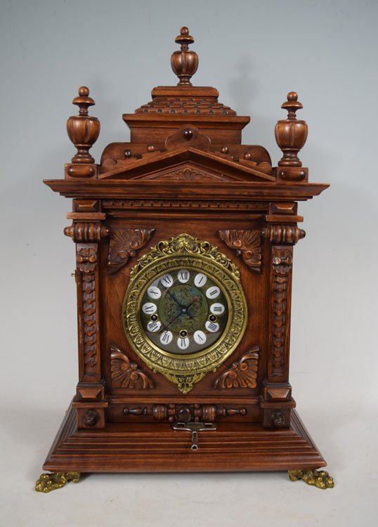 Gazo Oak Chiming Cabinet Clock: Gazo Oak "Mission Bay" Chiming Cabinet Clock: With an 8 day T&S with 8 bar strike and chime movement. The metal dial with a nude lady center has porcelain cartouche numerals. There are metal lion head