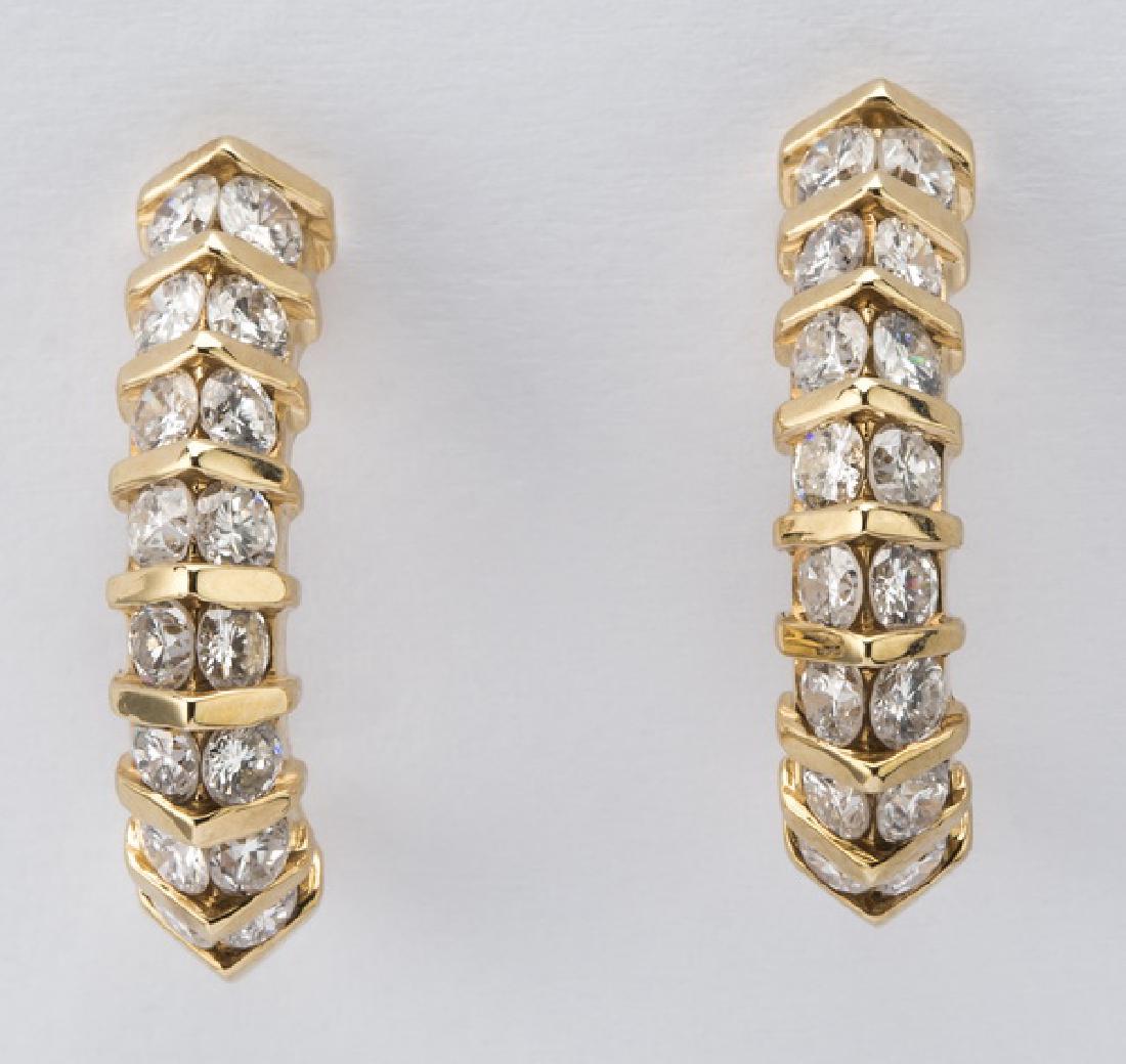 Pair of diamond & 14k 'J' hoop earrings, .75"l: Pair of diamond and 14k yellow gold 'J' hoop earrings, each channel set with (16) round brilliant diamonds, totaling 1.50ctw. of F-G color and VS-Si clarity, marked '14k,' on the post back, .75"l.