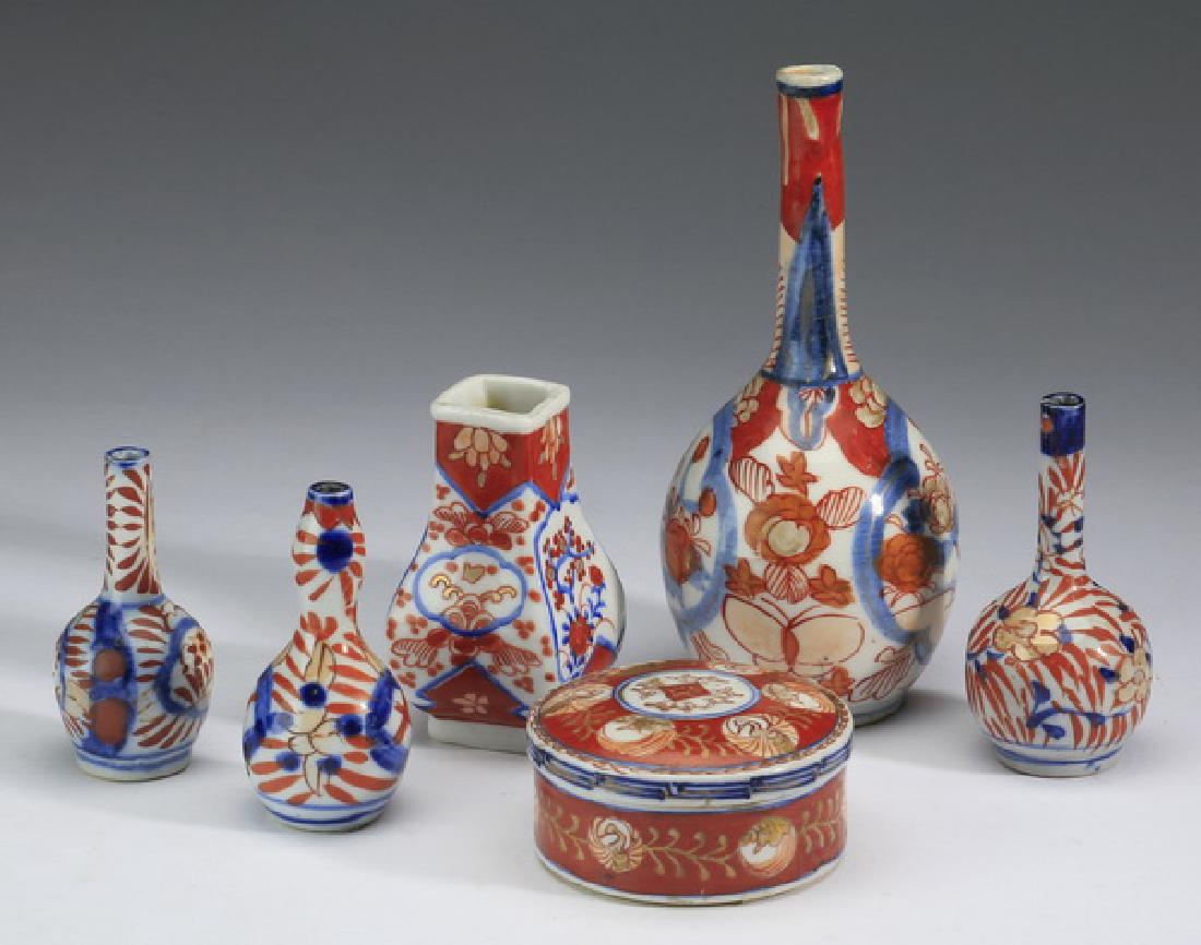 (6) Diminutive Imari porcelain vases: Group of six diminutive Imari porcelain vases, comprising a stick neck vase with floral cartouches, 7.5"h, a square vase with cartouches having waves and prunus branches, 4"h, (3) stick neck vases wit