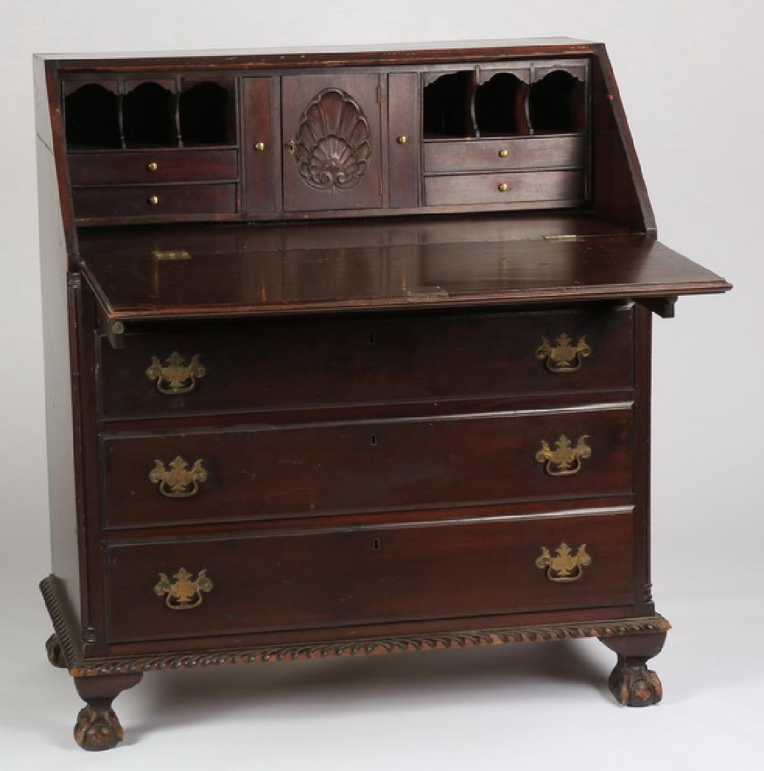 Late 19th c. slant front mahogany secretary, 38"w: Late 19th or early 20th century slant front mahogany secretary, with a fitted interior featuring a central shell carved door, all above four drawers, raised on ball and claw feet, 42.5"h x 37.5"w x 21