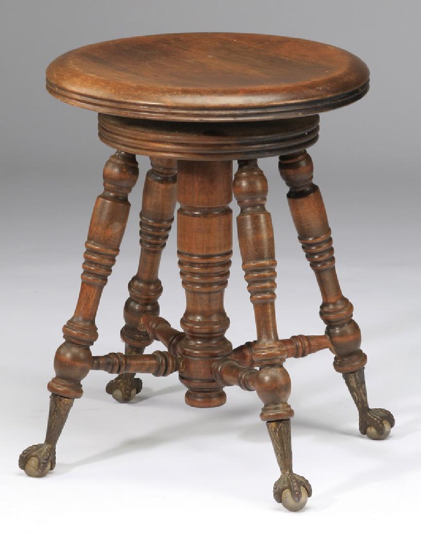 Victorian style swivel-top piano stool, 18"h: Victorian style piano stool, the swivel top rising on four turned legs terminating in gilt ball and claw feet, 18"h x 14.5"dia.