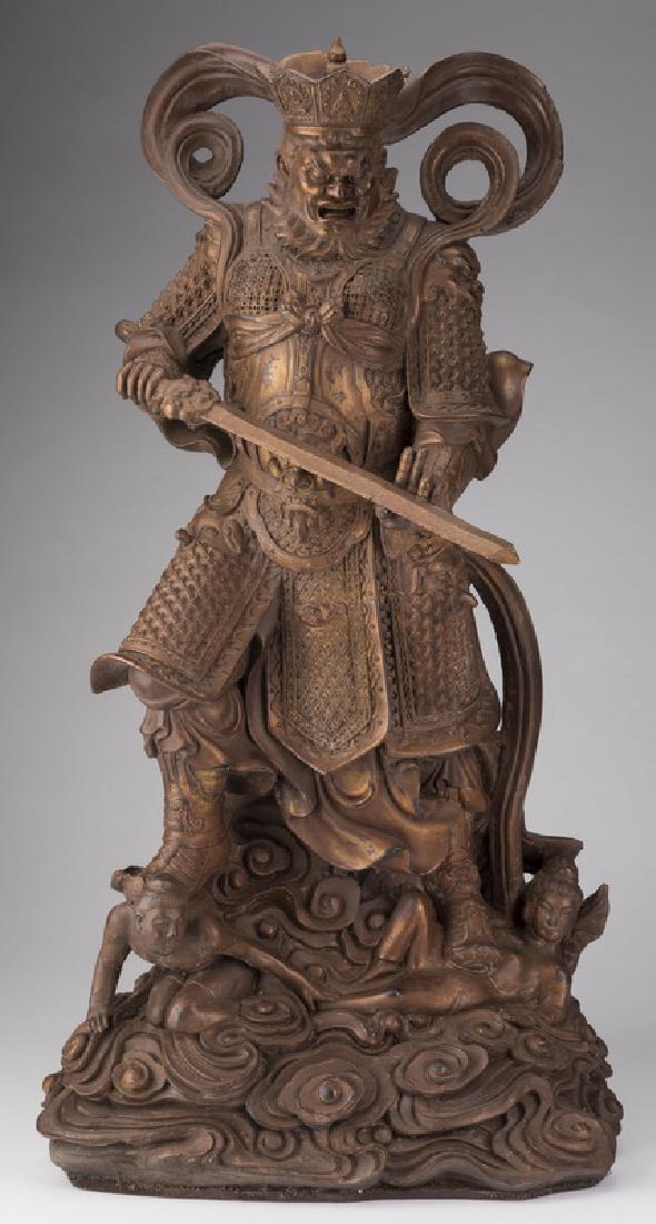Chinese dry lacquer sculpture of Virdhaka, 25"h: Chinese dry lacquer sculpture of Virdhaka, protector of the south and one of the Four Heavenly Kings, the deity is portrayed wearing a crown and armor and holding a magical sword while crushing demons