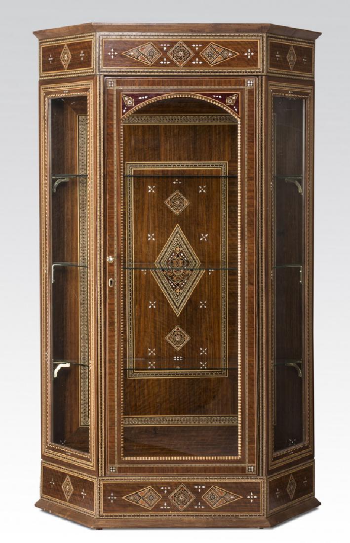 Moroccan inspired mother-of-pearl inlaid vitrine: Moroccan inspired parquetry inlaid vitrine, executed in mahogany with mother-of-pearl and light woods, having a molded cornice above a frieze filled with inlaid diamonds and triangles above an arched 