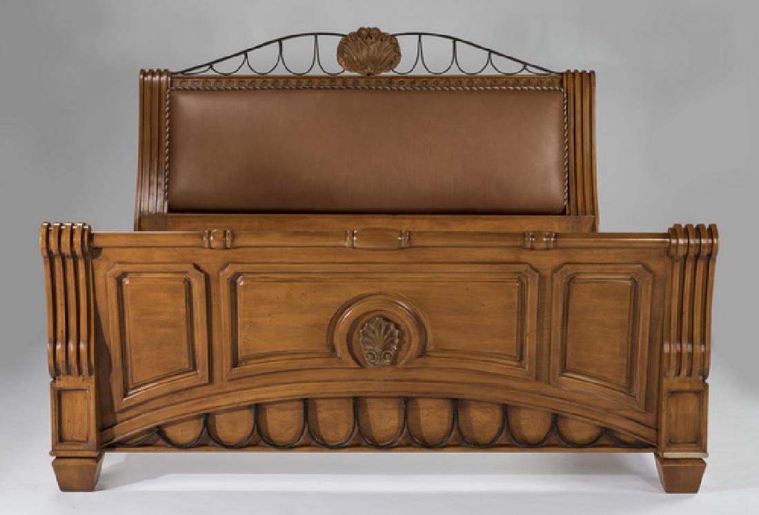 Contemporary king bedstead by Phyllis Morris, 63"h: Contemporary Phyllis Morris king bedstead, 20th century, having a central carved shell framed by an iron crest rail, above a carved rinceau band surmounting an upholstered leather back, joined to a sh