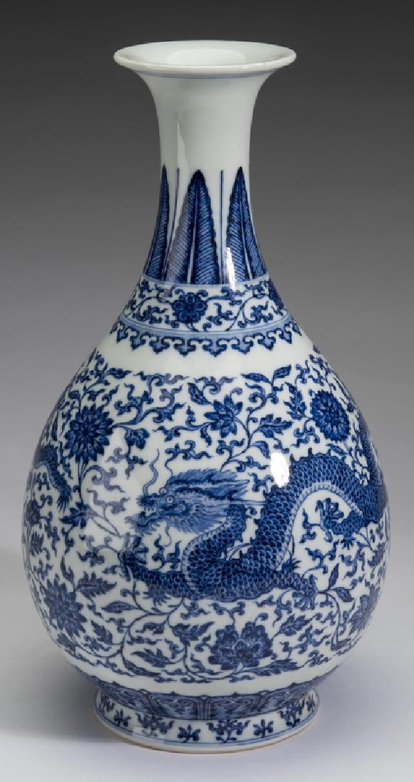 Chinese dragon motif vase, Qianlong mark, 12"h: Chinese blue and white dragon vase, of pear form, having a flared rim above a neck with plantain, peony scroll, and ruyi bands, the body decorated with writhing five clawed dragons on a lotus scroll g