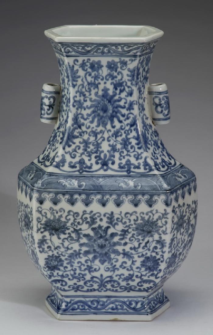 Chinese lotus scroll fanghu vase, Qianlong mark, 14"h: Chinese blue and white paneled fanghu vase, the trumpet neck flanked by barrel flange handles above lapping wave and lappet bands, the whole decorated with lotus scroll and tapering to an outswept foo