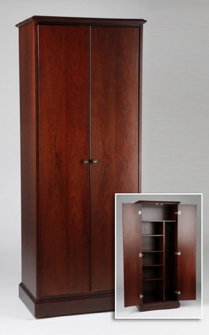 Steelcase executive mahogany storage cabinet, 77"h: Contemporay mahogany tall storage cabinet by Steelcase, opening to reveal a top shelf surmounting five smaller shelves to the left and coat hooks to the right, 77.25"h x 29.5"w x 18.5"d.