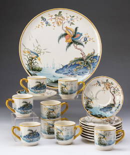 17-Piece Gien, France dessert service: Seventeen-piece dessert service by Gien, France in the 'Magellan' pattern, includes eight china cups and saucers together with a serving plate, each featuring a scene of rockwork and floral sprays,