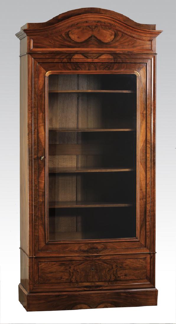 Federal style glass front bookcase in mahogany, 37"h: Federal style glass front bookcase, executed in mahogany, having a shaped arched cornice, above a shaped arched panel, surmounting the glass front cabinet door, opening to four wooden shelves, and ter