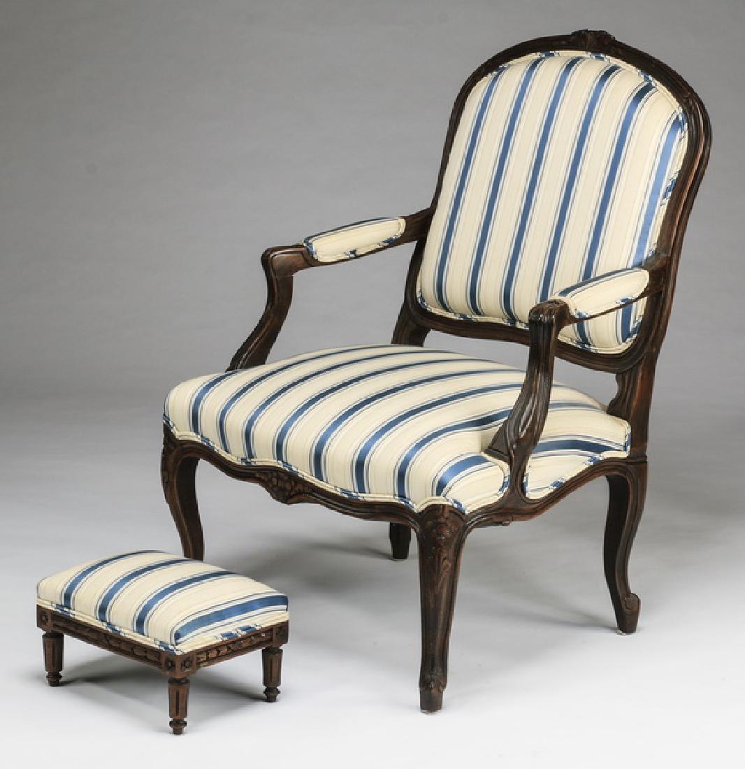 Louis XV style French fauteuil and footstool: Louis XV style French fauteuil and footstool, each with blue and white striped upholstery, the chair having a carved walnut frame, arched back, padded open arms, and resting on cabriole legs, 39"h x 2