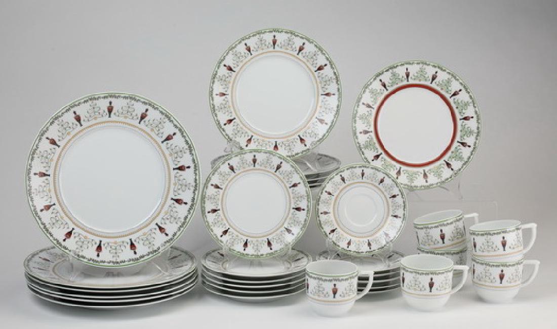 (30) Bernardaud Grenadiers table service for six: Grenadiers Happy Holiday porcelain table service for six by Bernardaud France, the rims decorated with Christmas trees and nutcracker soldiers with holly garland and a gilt band, comprising (6) dinner