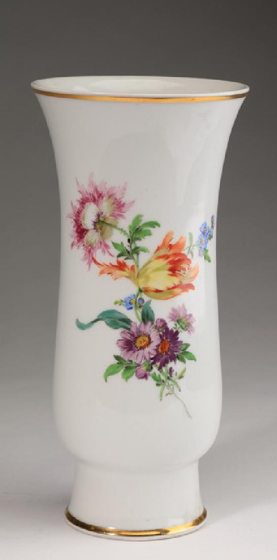 Hand painted Meissen porcelain vase, marked: Hand painted Meissen porcelain vase, early 20th century, having a flared gilt rim above a waisted body decorated with a central spray of colorful flowers accented with scattered blooms, rising on a ci