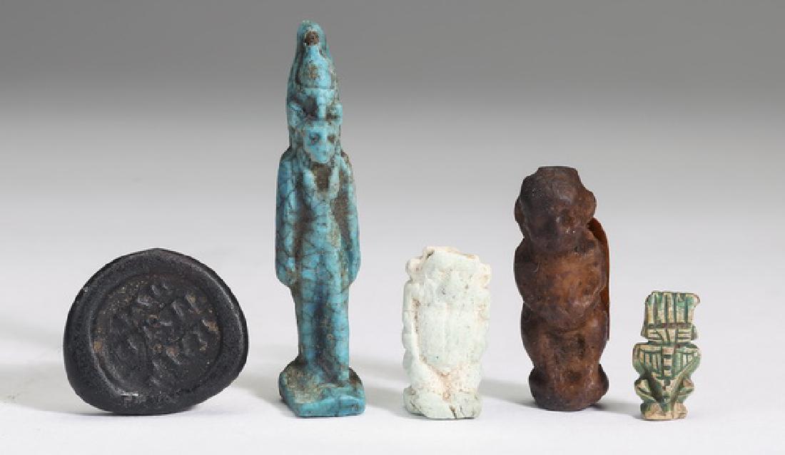 (5) Ancient artifacts, including Egyptian amulets: Five ancient artifacts, comprising four Egyptian amulets; a standing faience figure of 'Mehes the lion' in a pharaonic pose, 49mm x 10mm; a faience full-length figure of the minor god Bes depicted nud