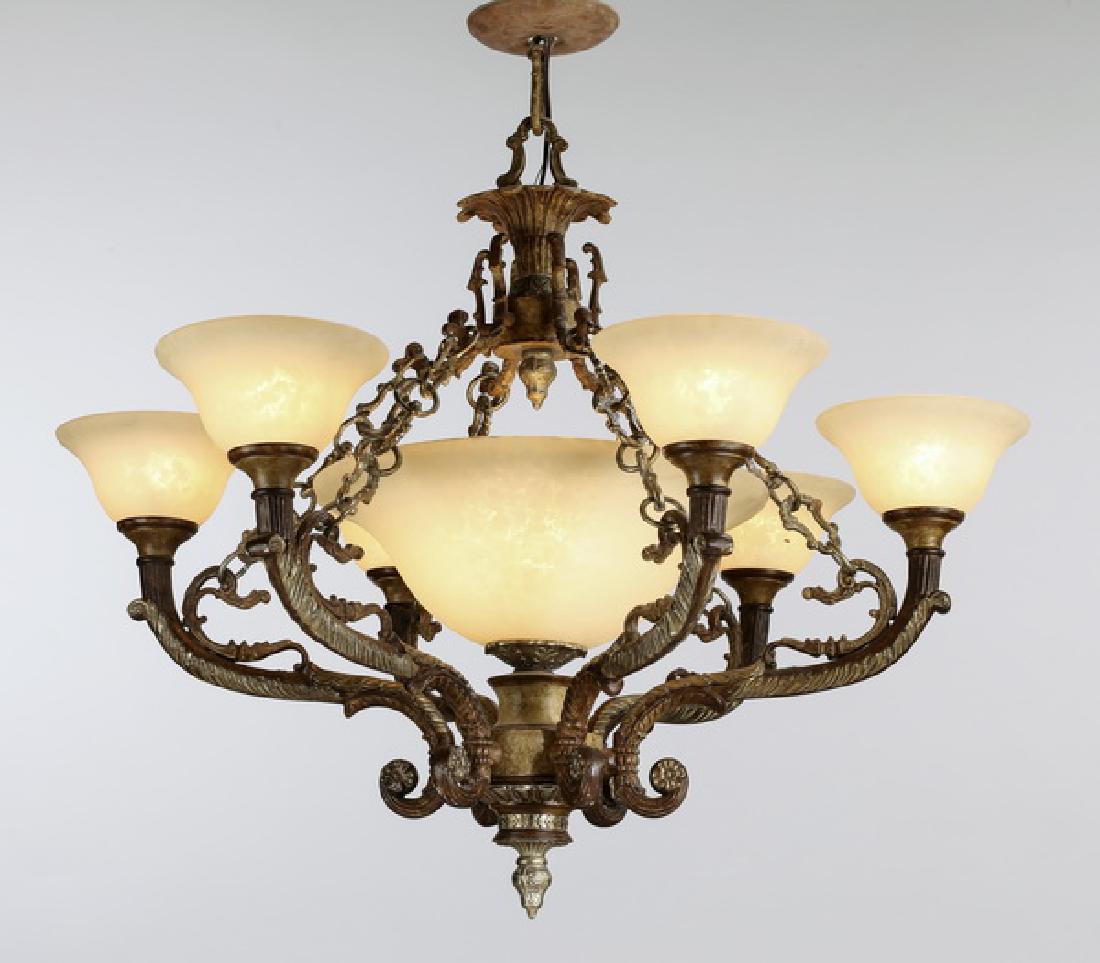 Patinated metal chandelier w/ glass shades: Renaissance Revival style six-arm chandelier, executed in patinated metal and composition material, having a foliate canopy issuing chains connected to six scrolling acanthus arms ending in flared par