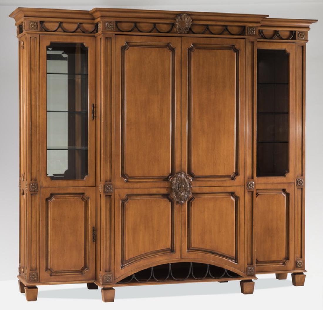 Contemporary entertainment unit by Phyllis Morris: Contemporary entertainment unit by Phyllis Morris, 20th century, having a molded cornice surmounting a band of alternating iron swags and carved rosettes with a central shell, above two over two doors