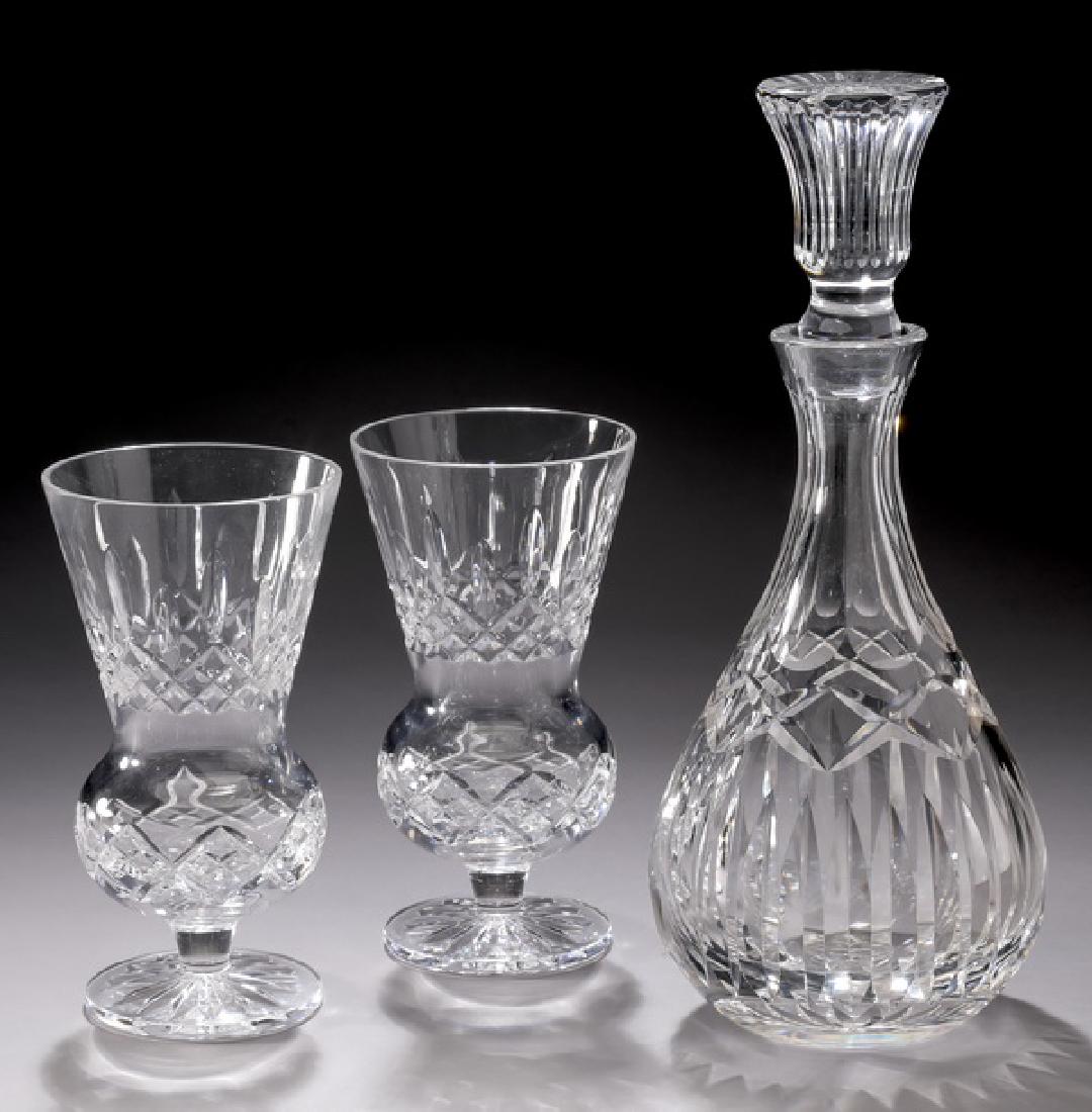 3 Pcs. Waterford crystal table accessories: Three pieces of Waterford crystal table accessories, comprising: (1) decanter, 12"h; together with (2) thistle vases in the 'Lismore' pattern, 7.25"h; each having a cut geometric motif, with acid etch