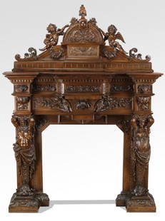 Elaborately carved 19th c. Italian figural mantel: Elaborately carved 19th century Italian walnut fireplace surround, the arched crest centering ribbon-tied acanthus surmounted by flowers and flanked by seated putti above a sheep's head mask terminati