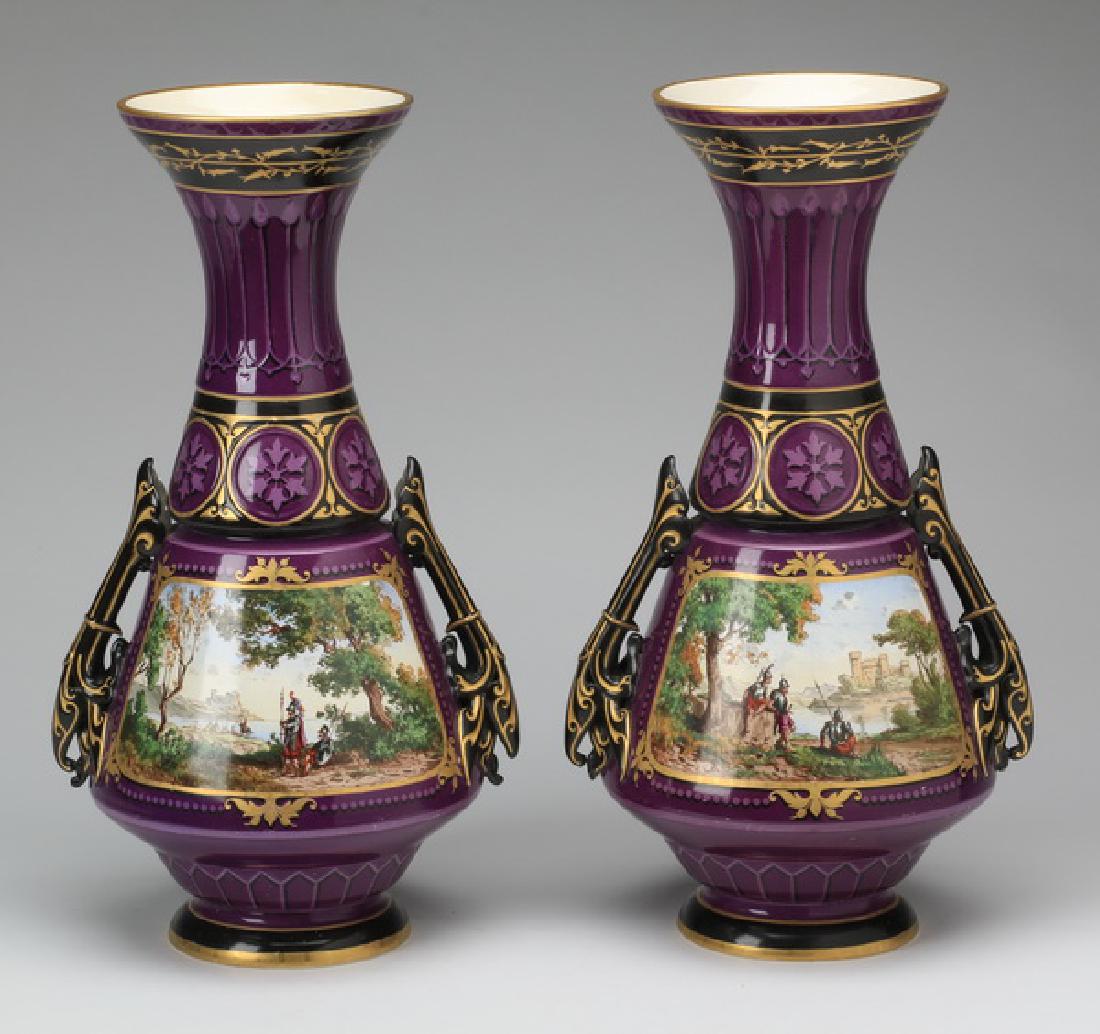 (2) Sarreguemines hand decorated vases, 20"h: Pair of early 20th century hand painted Sarreguemines vases, of baluster form decorated in deep purple with black and gilt accents, having flared necks with gilt rims accented with black bands with gi