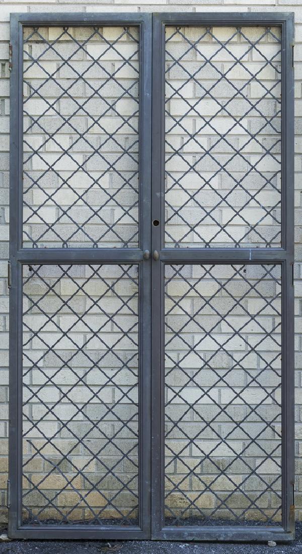 Brass and bronze latticework doors: Latticework brass and bronze doors, of rectangular form, comprising two door panels decorated with open latticework, and a central turning knob, 76"h x 41"w.
