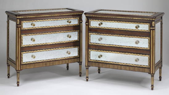 (2) E.J. Victor three drawer mirrored chests: Pair of E.J. Victor 'Julia Gray Collection' mirrored chests in the Louis XVI taste, executed in antiqued mirror and mahogany veneer with gold accents, each having a rectangular top with an inset mirro