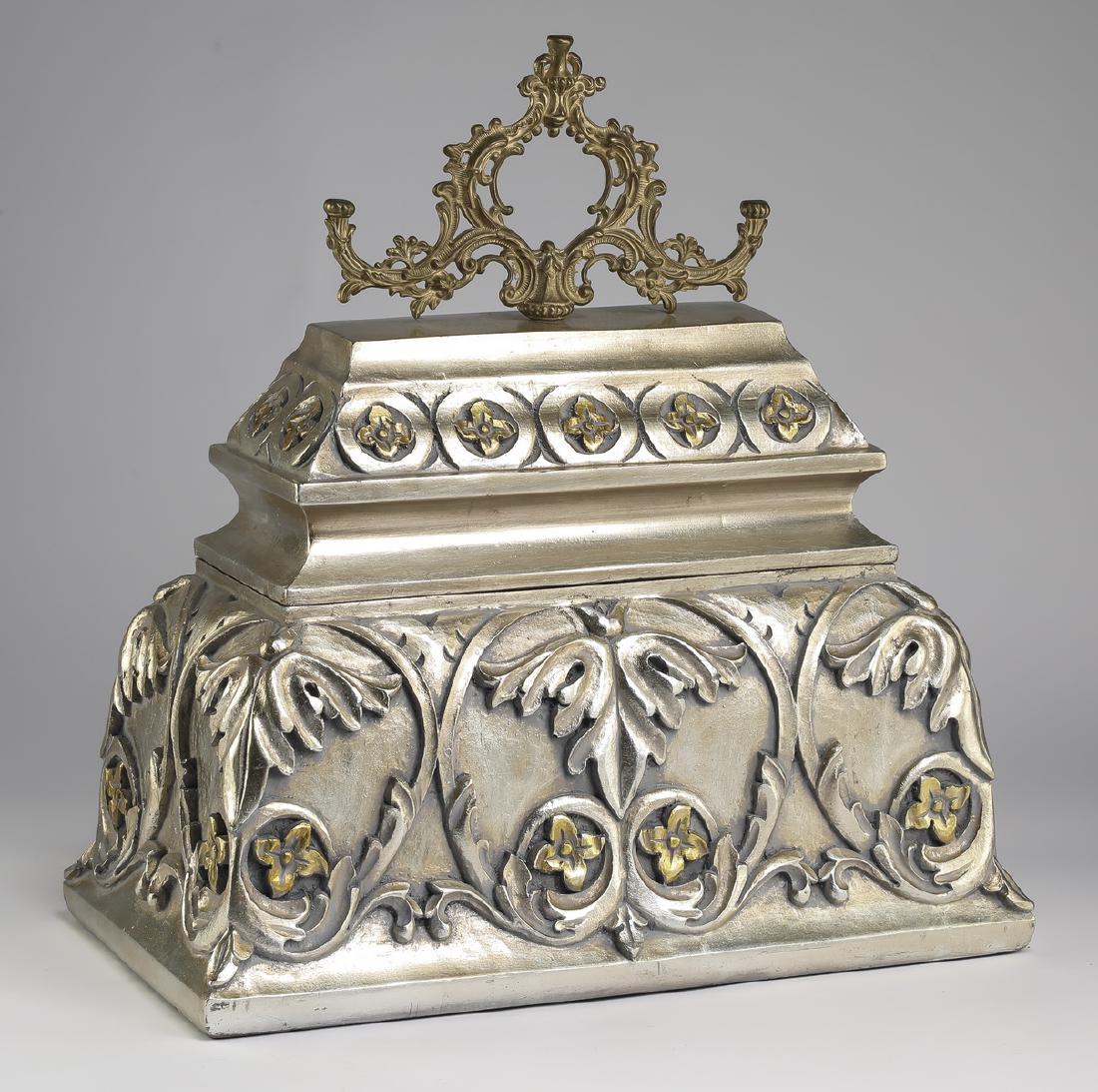 French inspired silver accented carved box, 20"h: French inspired silver accented carved wood lidded box, having a bronze scrollwork finial set into the shaped lid with a rosette carved rim, opening to open storage space, above a foliate scrollwork c