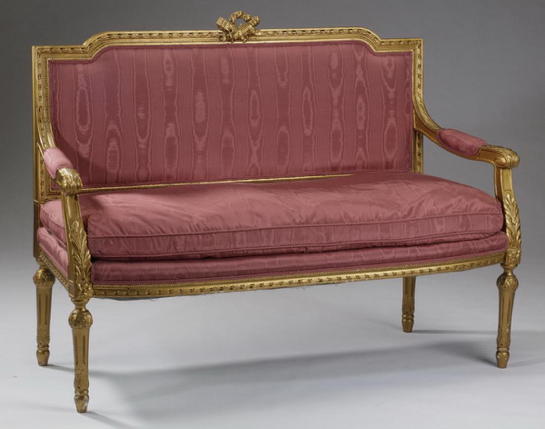 Gilt wood settee in rose satin fabric, 56"l: Louis XVI style giltwood settee upholstered in rose moirÃ© fabric, with a carved beaded and acanthus frame, on tapering stop fluted legs, 38"h x 52.5"l x 20"d; seat, 19"h.