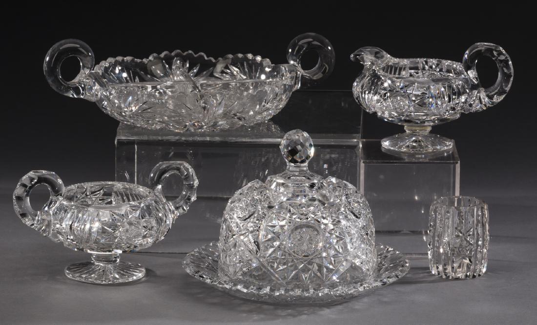 (5) Cut crystal hobstar pattern table accessories: Cut crystal table accessories, comprising: (1) scalloped rim relish plate with handles 9.75"w x 6.75"d; (1) toothpick holder 2.5"h x 1.75"dia; (1) creamer 3.75"h x 5.5"w x 3.5"d; (1) sugar 3.5"h x 5.7