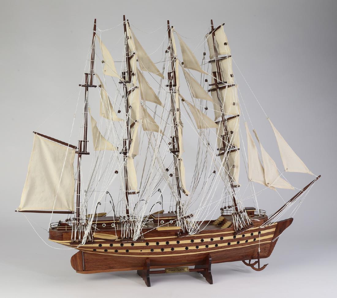 Model of the 4-masted barque Marie Claire, 32"l: Model of a four masted barque, having sails, rigging, life boats ,and anchors, the body of the vessel executed in contrasting woods, resting on a custom stand with a plaque indicating the name Marie C