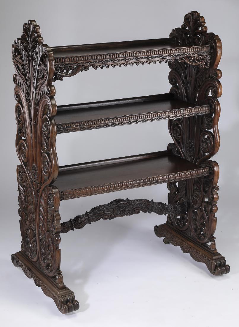19th c. American carved walnut canterbury, 54"h: American Renaissance Revival carved walnut canterbury, 19th century, having three gadrooned edged shelves, flanked by pierced carved scrolling foliate supports, connected by foliate carved stretcherin