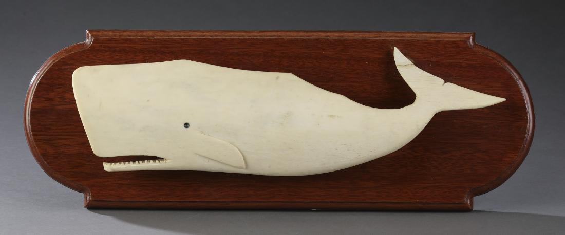 Carved bone Sperm whale on mahogany plaque, 19"w: Carved bone Sperm whale on mahogany plaque, 6.5"h x 19"w.