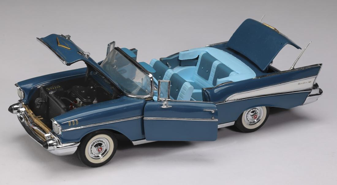 Danbury Mint 1957 blue Chevrolet Bel Air, 2"h: Danbury Mint 1957 blue Chevrolet Bel Air, die-cast at 1:24 scale, marked, 2.25"h x 3"w x 8.75"d.