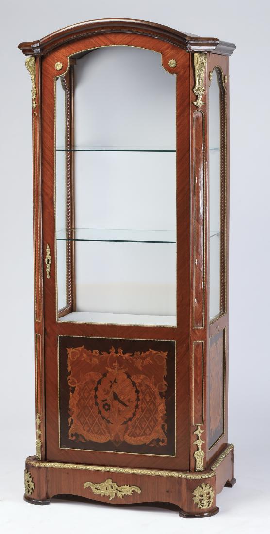 Italian mahogany & marquetry inlaid vitrine, 72"h: Italian mahogany and marquetry inlaid vitrine with gilt mounts, having an arched cornice above a glazed door opening to a fabric lined interior with two glass shelves, with glazed side lights interspa