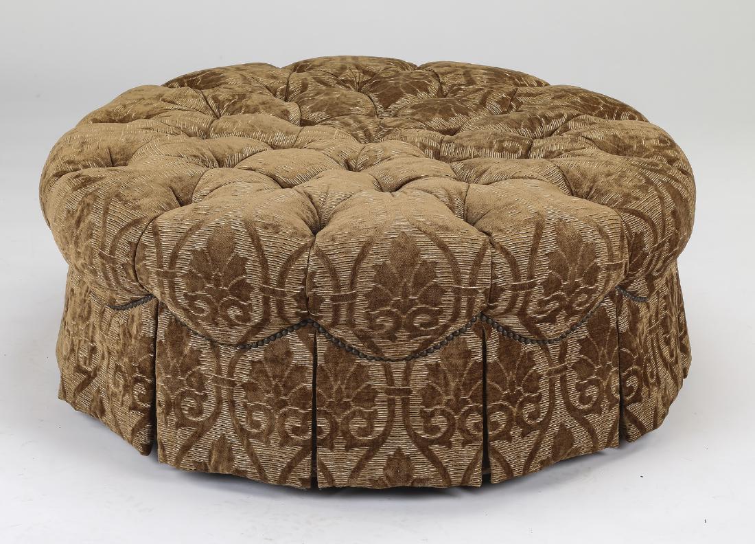 Henredon circular button-tufted upholstered ottoman: Henredon button-tufted ottoman, the circular ottoman having all-over upholstery in an acanthus scroll pattern, with a button-tufted top and a fully skirted base, 16"h x 42"dia.