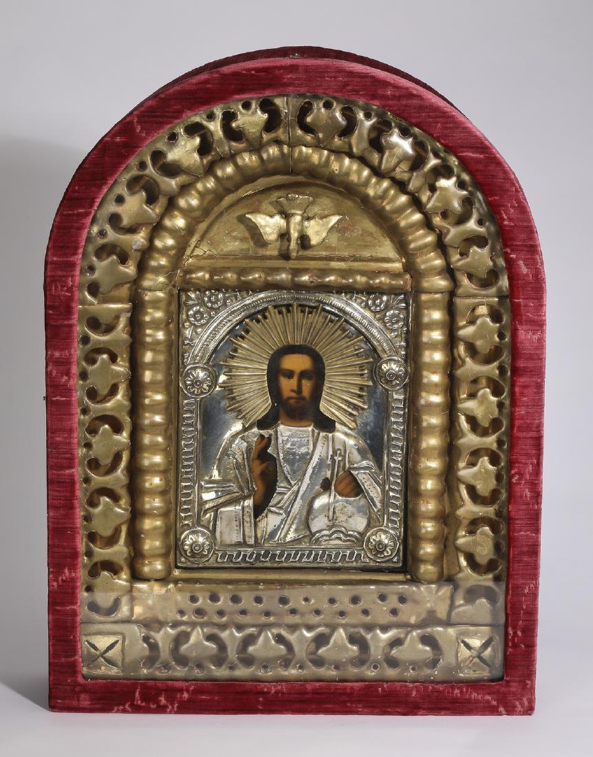 Orthodox icon of Christ Pantocrator in velvet kiot: Orthodox icon, 19th century, oil on panel depicting Christ Pantocrator under a silvered metal oklad, surounded by a gilt reticulated insert with descending dove, the whole enclosed in an arched red ve