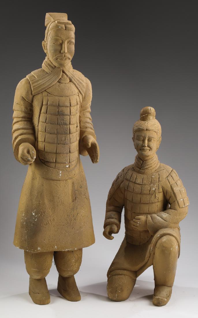 (2) Chinese terracotta warrior replicas, taller 38"h: Two Chinese terracotta warrior replicas, each having an elaborate coiffeur and mustache, and wearing lamellor or scale armor, one standing with arms bent ready to hold a weapon, 37.5"h x 9.5"w x 9"d; 