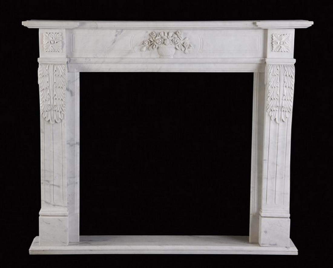 Hand carved Louis XVI style marble mantel: Louis XVI inspired hand carved white marble mantel, the frieze with a central floral filled vase flanked by square paterae, over ribbed pilasters surmounted with scrolling acanthus leaves, all raised 