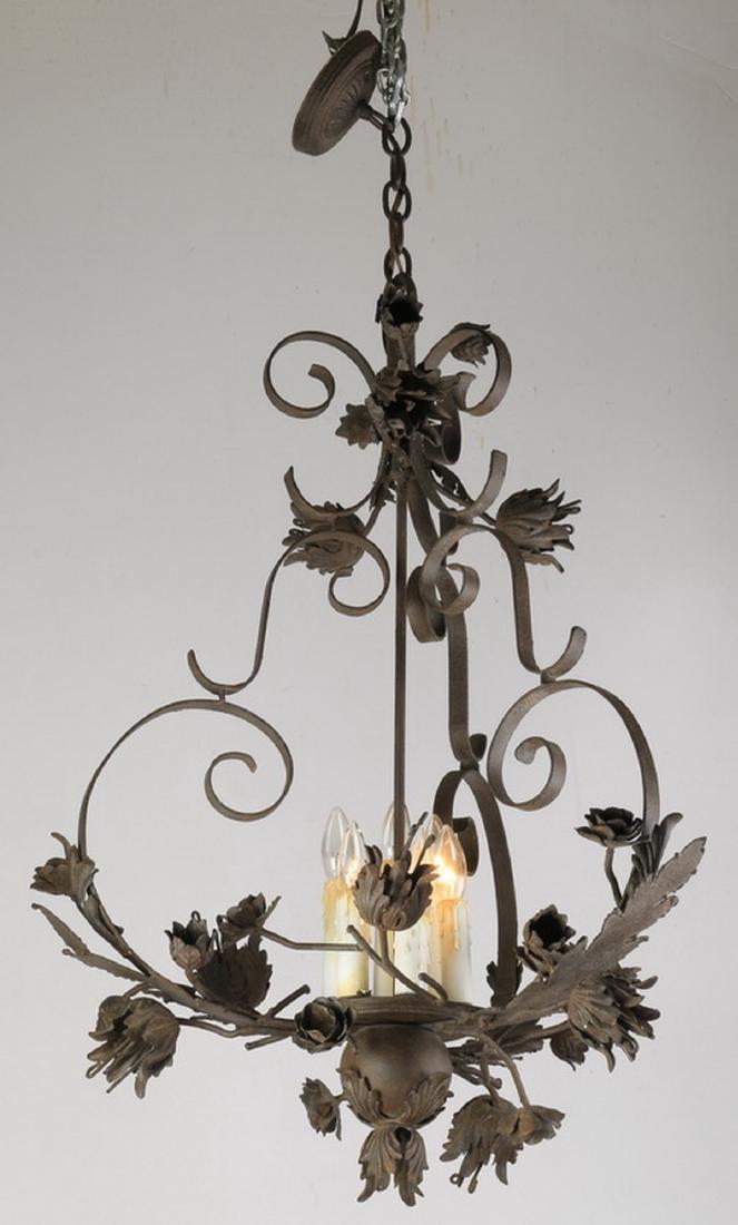 Rococo inspired 5-light tole chandelier, 47"h: Tole peinte chandelier in the Rococo taste, with C and S-scroll supports terminating in figural leaves and flowers, the central column with five electrified faux candles, 47"h x 20" dia.