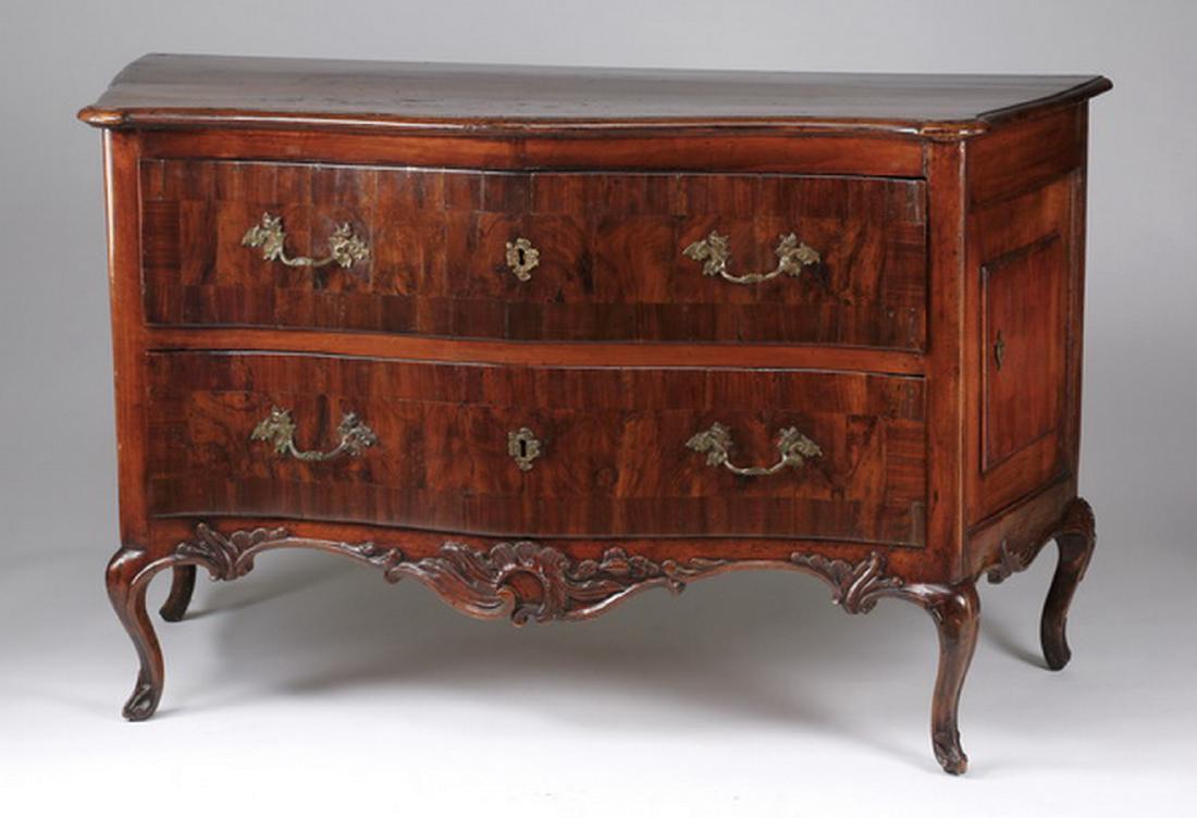 18th c. Continental serpentine commode: Continental serpentine front commode, late 18th or early 19th century, the conforming top surmounting two drawers with provincial style pulls centering foliate form keyhole escutcheon plates, with sep